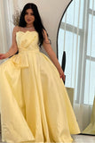 Yellow evening dress with a bow