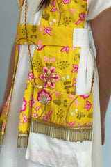 A Kuwaiti girls' jalabiya with a flowing shawl, embroidered and decorated with yellow tassels 