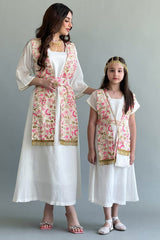 A Kuwaiti girls' jalabiya with a flowing shawl, embroidered and decorated with tassels, in beige colour 