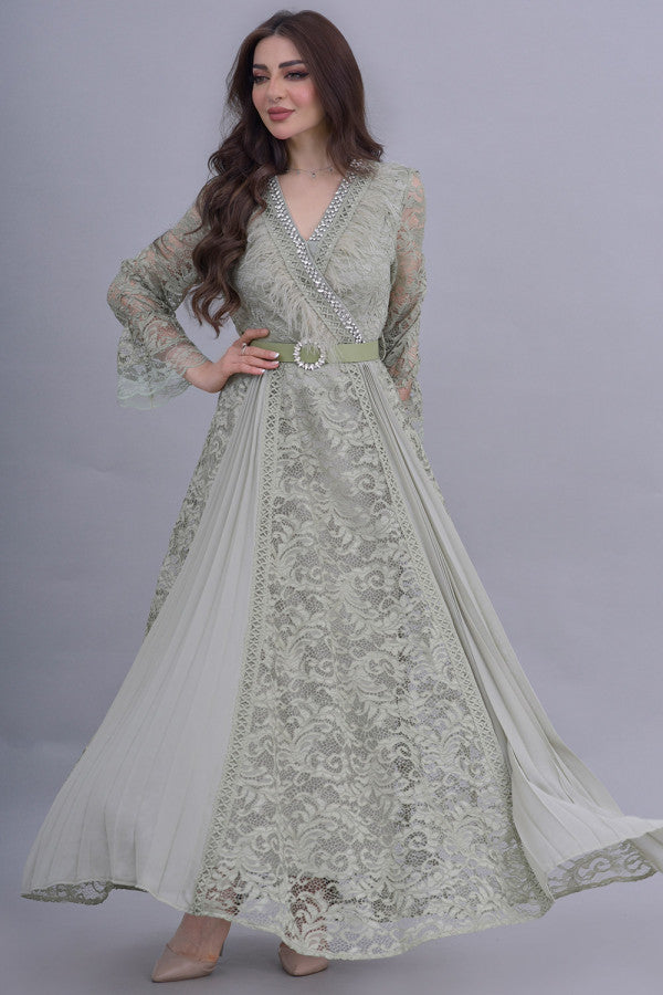 Green lace dress decorated with crystals and feathers