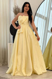 Yellow evening dress with a bow