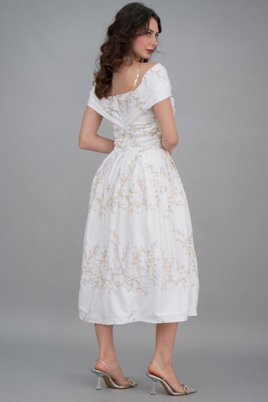 White pleated evening dress embroidered with silver threads