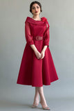 Classic collared dress decorated with red feathers 