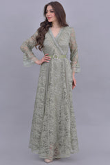 Green lace dress decorated with crystals and feathers