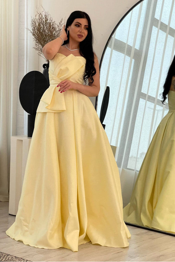 Yellow evening dress with a bow