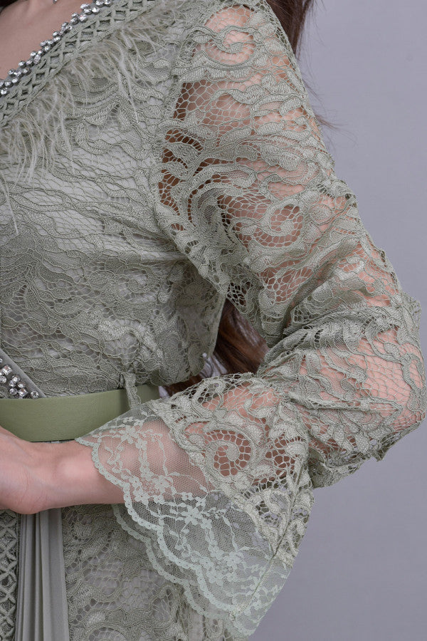 Green lace dress decorated with crystals and feathers