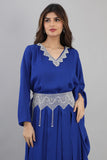 A modern galabiya with a distinctive design, embroidered with beads and indigo colour