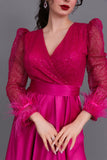 Long dress with sequined bodice and feathers, fuchsia color