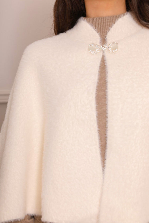 Elegant winter shawl with a white brooch 