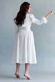 White midi dress with side slits and feathers