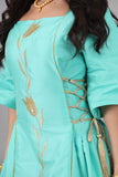 A modern galabiya with ties on the sides, turquoise color