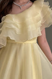 Yellow one-shoulder cloche dress with layers of ruffles